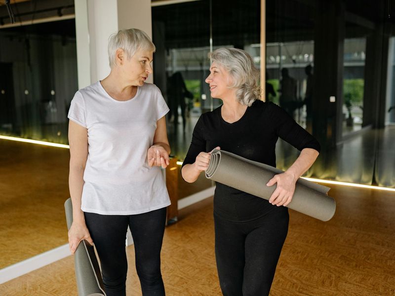 Spacious, well-lit studio with yoga mats ready for a workout.
